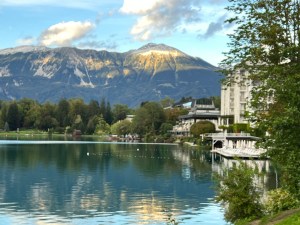 The snow-capped Karawanks mountain range towers above Old Town Bled. The Grand Hotel Toplice is in the forefront.