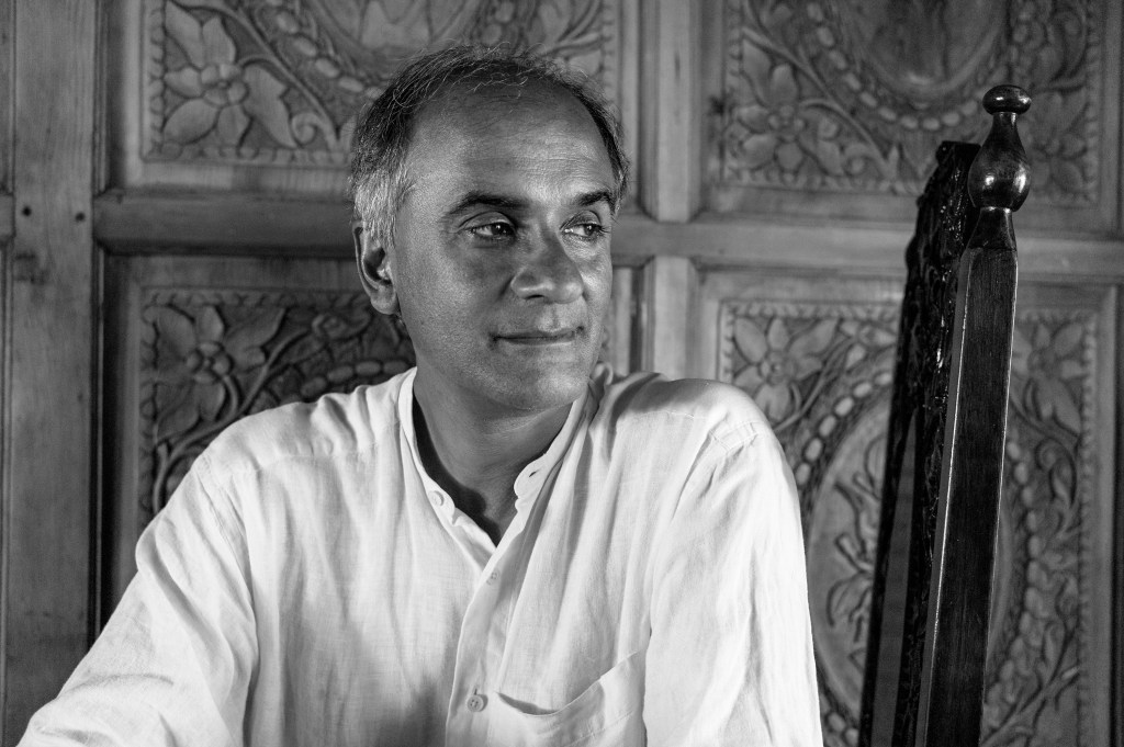 Book review of Pico Iyer's book, "The Half Known Life: In Search of Paradise" by Travel The Four Corners. Photo of Pico Iyer by Brigitte Lacombe. Published with permission of Pico Iyer.